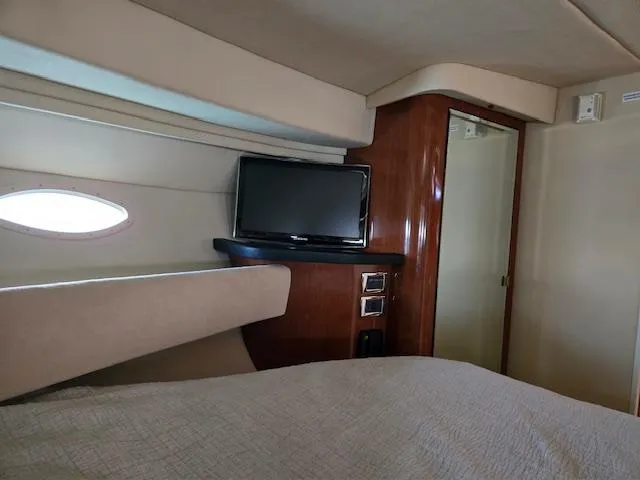 2 Spicy Yacht Photos Pics Interior cabin of 2003 Sea Ray 380 Sundancer with TV and wood paneling.