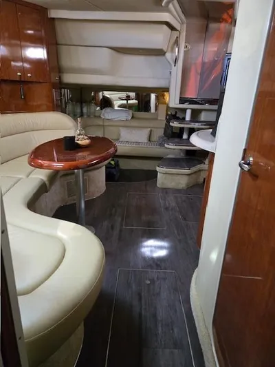 2 Spicy Yacht Photos Pics Luxurious interior of a 2003 Sea Ray 380 Sundancer yacht with elegant seating and wood finishes.