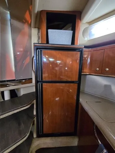 2 Spicy Yacht Photos Pics 2003 Sea Ray 380 Sundancer interior with wooden cabinetry and compact refrigerator.