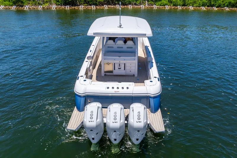  Yacht Photos Pics 2025 Intrepid 41 Panacea boat with triple outboard engines on water.