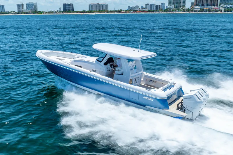  Yacht Photos Pics 2025 Intrepid 41 Panacea cruising on ocean near city skyline.