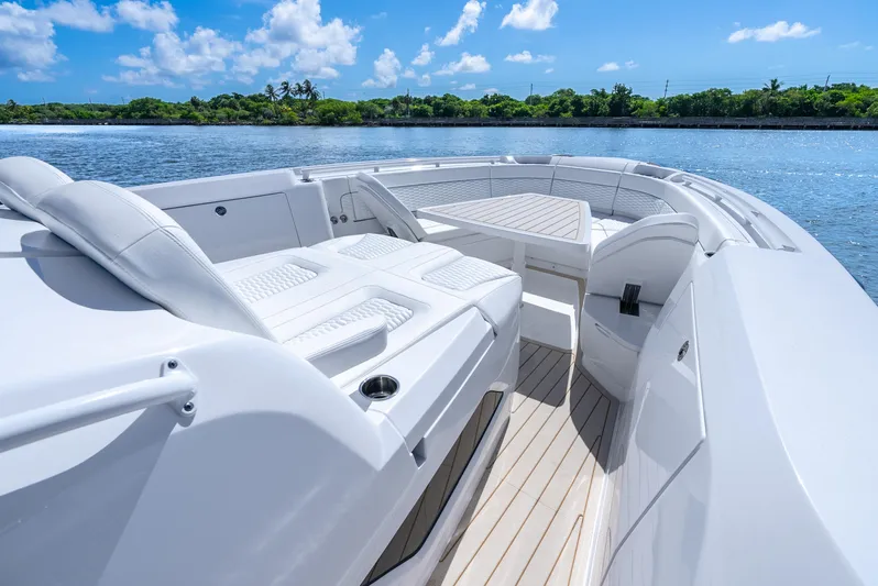  Yacht Photos Pics Luxurious 2025 Intrepid 41 Panacea boat interior with white seating and scenic water view.