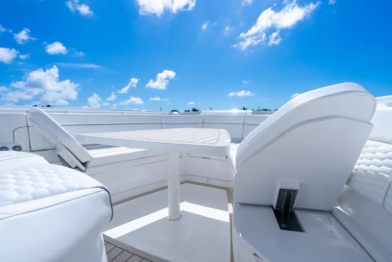 Yacht Photos Pics Luxurious seating on 2025 Intrepid 41 Panacea yacht under clear blue sky.