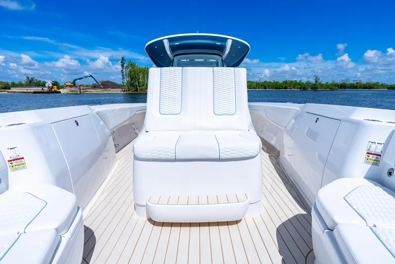  Yacht Photos Pics 2025 Intrepid 41 Panacea boat interior with sleek white seating and open water view.