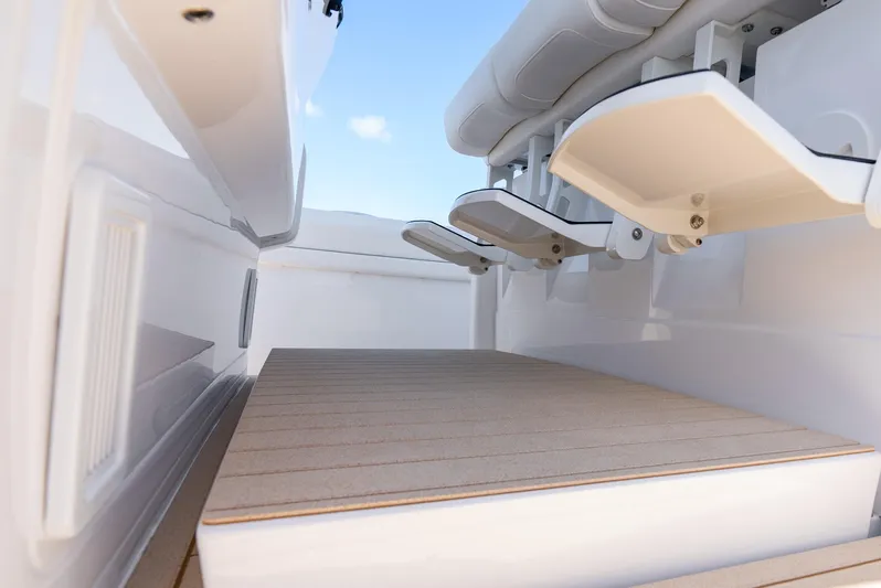  Yacht Photos Pics Intrepid 41 Panacea 2025 boat interior with foldable seats and wooden flooring.