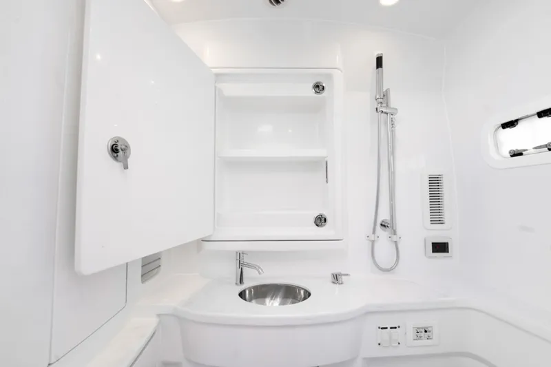  Yacht Photos Pics 2025 Intrepid 41 Panacea boat bathroom with sleek white design and modern fixtures.