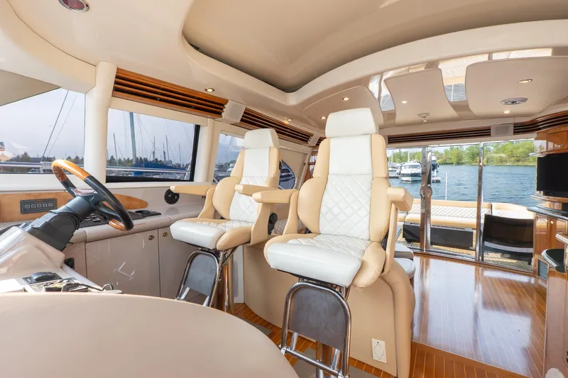  Yacht Photos Pics Luxurious interior of 2003 Sea Ray 680 Sun Sport yacht with plush seating and panoramic windows.