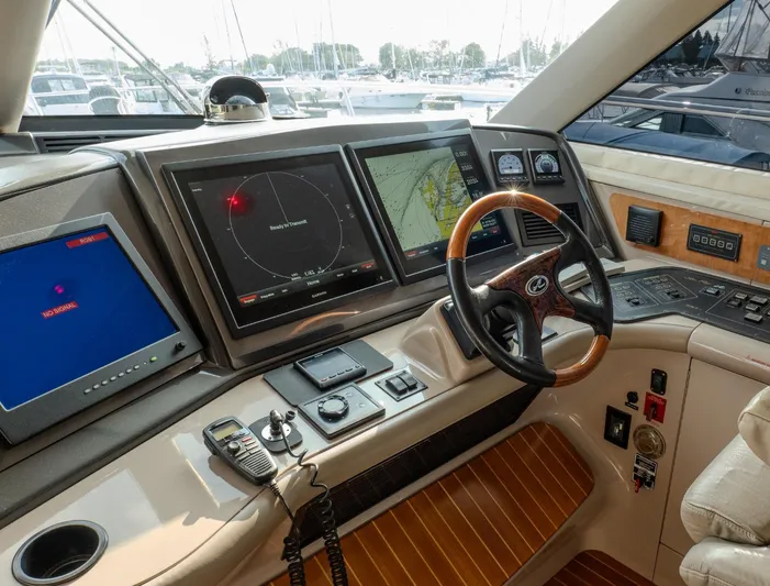  Yacht Photos Pics Cockpit of 2003 Sea Ray 680 Sun Sport with advanced navigation systems and wooden steering wheel.