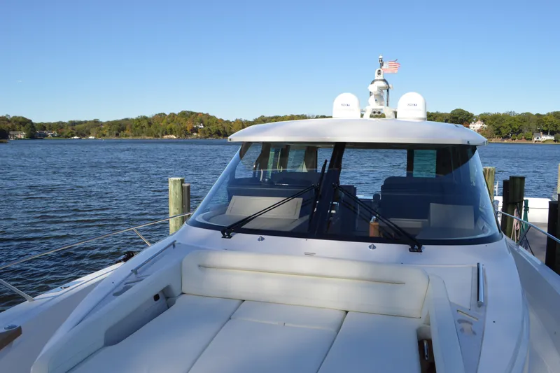 Jack's Boat Yacht Photos Pics 2024 Tiara Yachts EX 60 luxury yacht docked by serene waters.