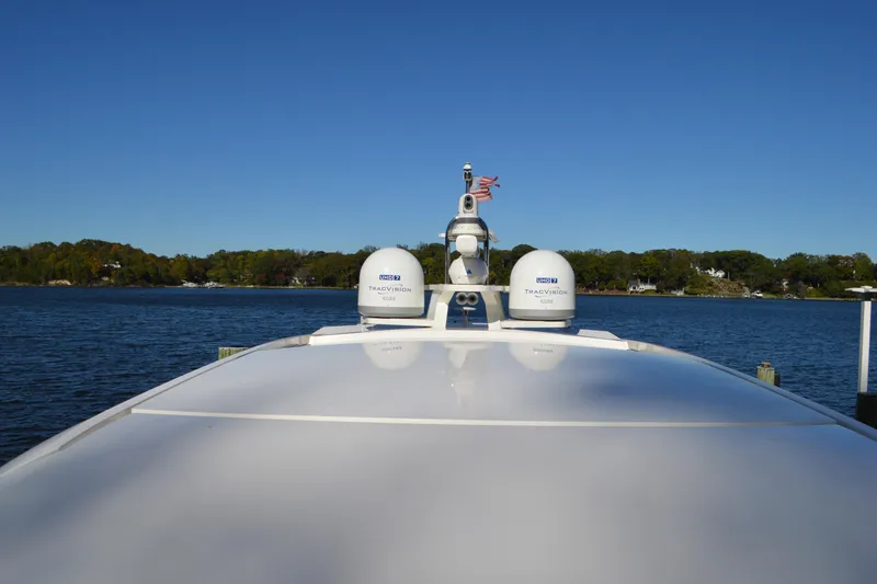 Jack's Boat Yacht Photos Pics 2024 Tiara Yachts EX 60 on water, featuring radar domes and clear blue sky.