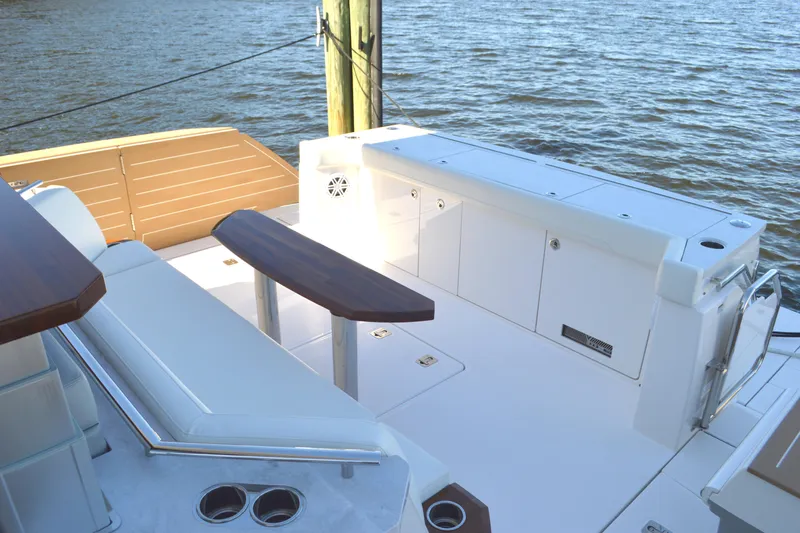 Jack's Boat Yacht Photos Pics 2024 Tiara Yachts EX 60 deck with seating and storage, overlooking water.