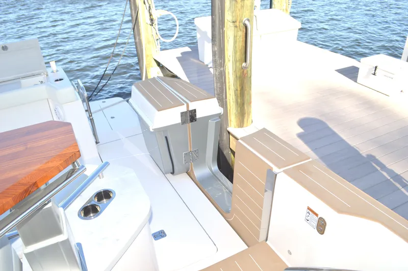 Jack's Boat Yacht Photos Pics 2024 Tiara Yachts EX 60 docked, showcasing deck and seating area by the water.