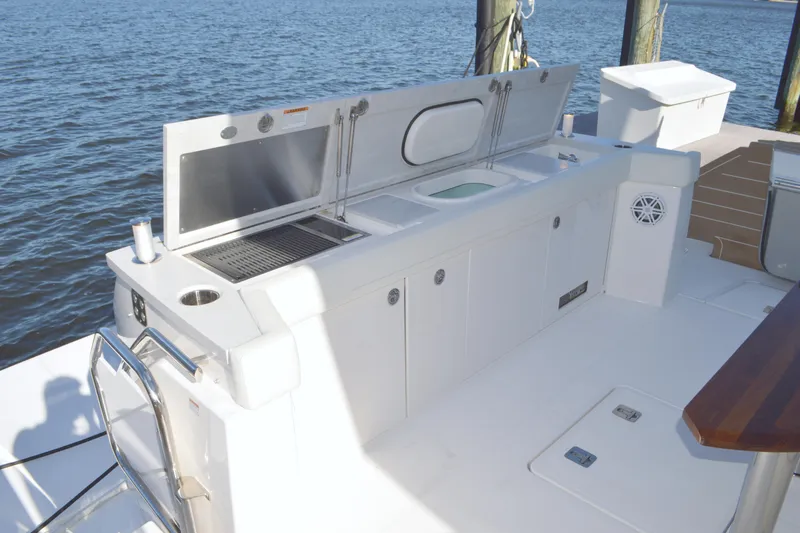 Jack's Boat Yacht Photos Pics Outdoor kitchen on 2024 Tiara Yachts EX 60, featuring grill and sink by the water.