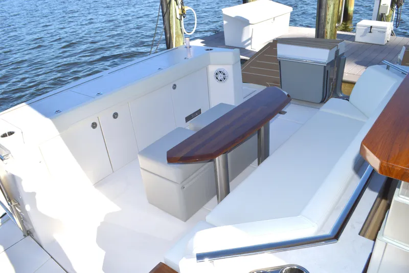 Jack's Boat Yacht Photos Pics Luxurious seating area on 2024 Tiara Yachts EX 60, docked by the water.