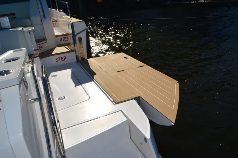 Jack's Boat Yacht Photos Pics 2024 Tiara Yachts EX 60 swim platform and steps, docked by the water.