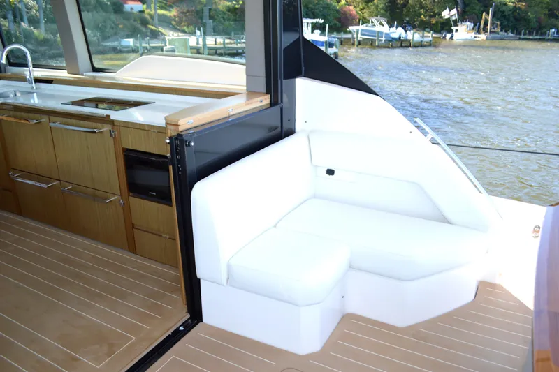 Jack's Boat Yacht Photos Pics 2024 Tiara Yachts EX 60 interior with kitchen and seating area by the water.