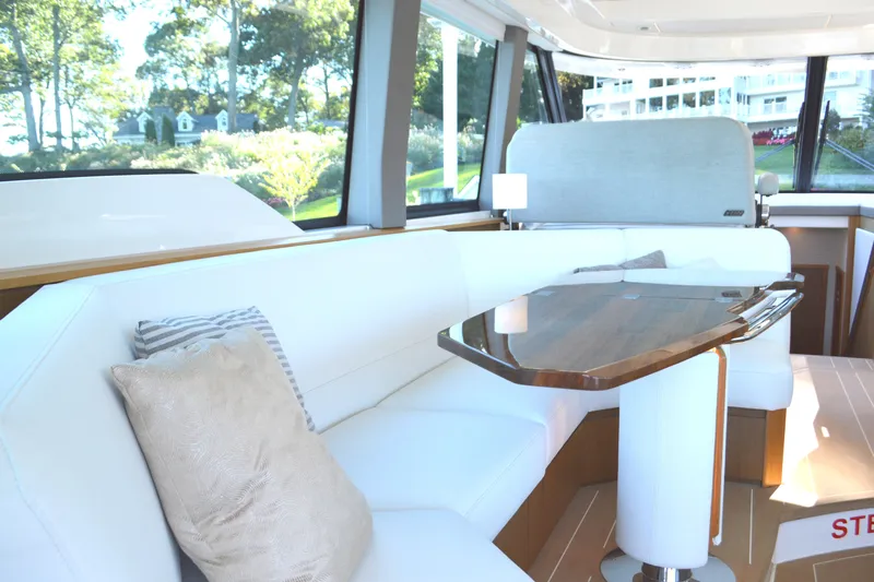 Jack's Boat Yacht Photos Pics Luxurious interior of 2024 Tiara Yachts EX 60 with elegant seating and wooden table.