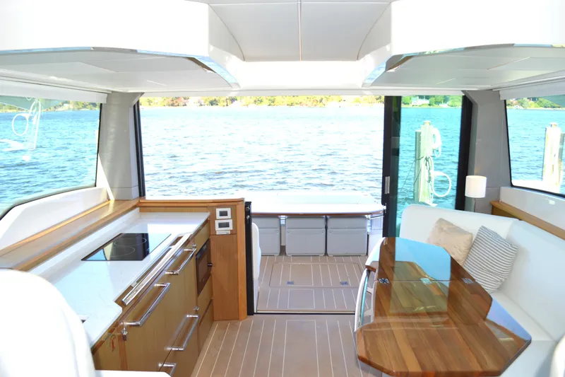 Jack's Boat Yacht Photos Pics Luxurious interior of 2024 Tiara Yachts EX 60 with modern kitchen and scenic water view.