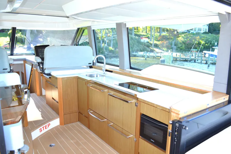 Jack's Boat Yacht Photos Pics Luxurious interior of 2024 Tiara Yachts EX 60, featuring modern kitchen and panoramic windows.