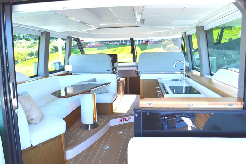 Jack's Boat Yacht Photos Pics Luxurious interior of 2024 Tiara Yachts EX 60, featuring modern seating and sleek kitchen area.