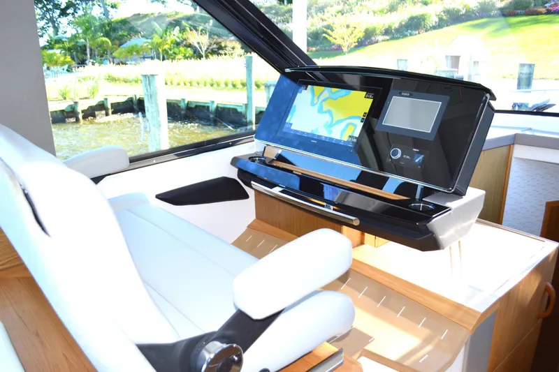 Jack's Boat Yacht Photos Pics 2024 Tiara Yachts EX 60 helm with advanced navigation display and luxurious seating.
