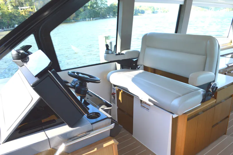 Jack's Boat Yacht Photos Pics 2024 Tiara Yachts EX 60 helm with modern controls and comfortable seating.