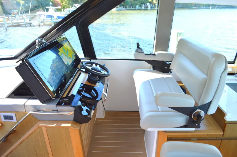 Jack's Boat Yacht Photos Pics 2024 Tiara Yachts EX 60 helm with modern controls and luxurious seating.