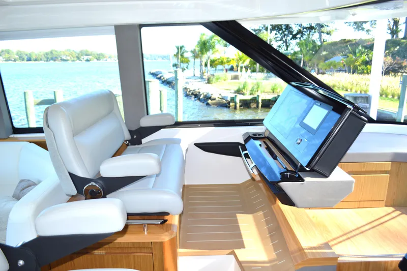 Jack's Boat Yacht Photos Pics 2024 Tiara Yachts EX 60 helm with luxurious seating and advanced navigation system.