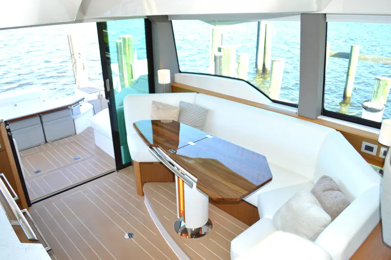 Jack's Boat Yacht Photos Pics Luxurious interior of 2024 Tiara Yachts EX 60 with elegant seating and wooden table.