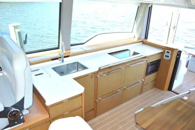 Jack's Boat Yacht Photos Pics Luxurious 2024 Tiara Yachts EX 60 interior kitchen with modern appliances and sleek design.