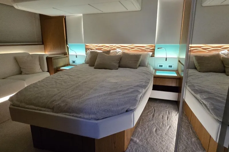 Jack's Boat Yacht Photos Pics Luxurious bedroom interior of 2024 Tiara Yachts EX 60 with modern design and ambient lighting.