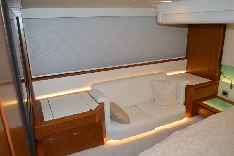 Jack's Boat Yacht Photos Pics Luxurious interior of 2024 Tiara Yachts EX 60 with elegant white sofa and wooden accents.