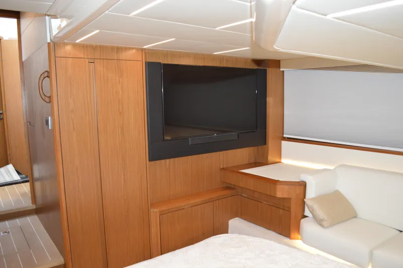 Jack's Boat Yacht Photos Pics 2024 Tiara Yachts EX 60 interior with TV, wood paneling, and white seating.