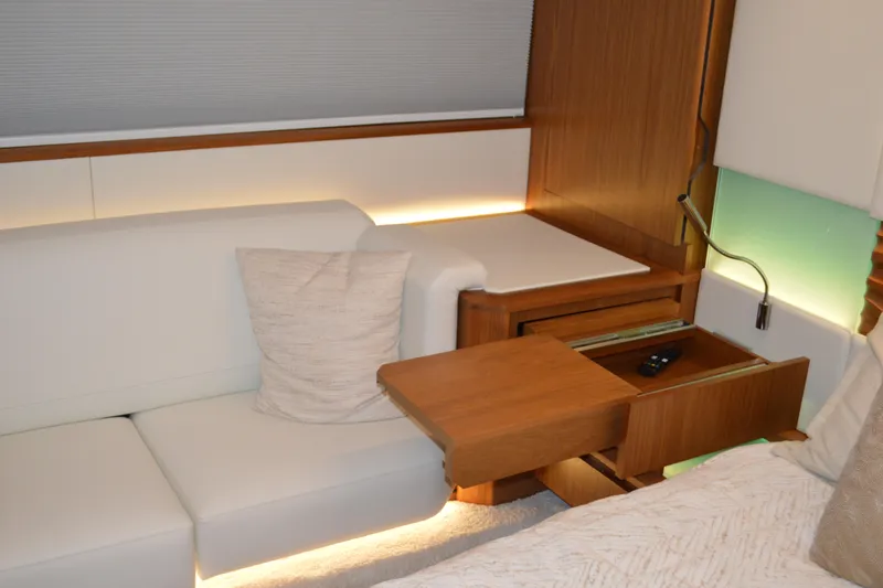 Jack's Boat Yacht Photos Pics Luxurious interior of 2024 Tiara Yachts EX 60 with elegant wood and white upholstery.