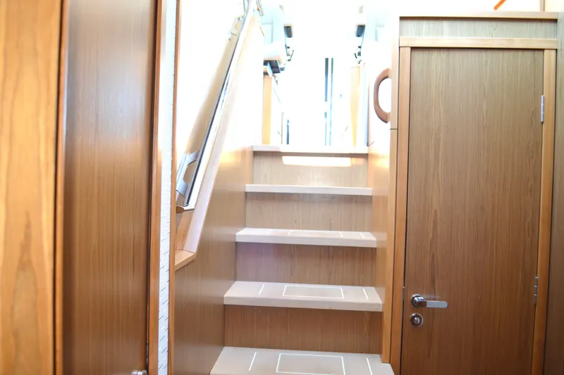 Jack's Boat Yacht Photos Pics 2024 Tiara Yachts EX 60 interior staircase with wooden finish and modern design.