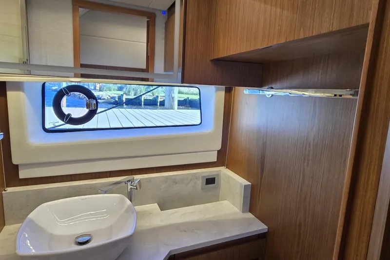 Jack's Boat Yacht Photos Pics Luxurious bathroom interior of 2024 Tiara Yachts EX 60 with modern sink and window view.