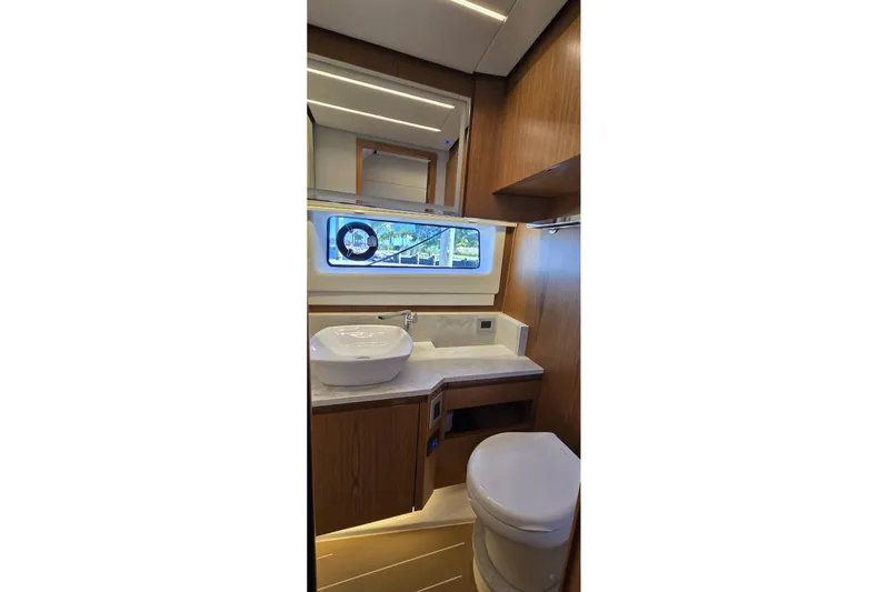 Jack's Boat Yacht Photos Pics Luxurious bathroom interior of 2024 Tiara Yachts EX 60 with modern fixtures and wood accents.