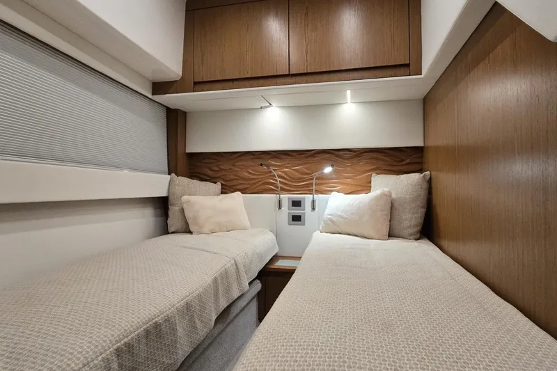 Jack's Boat Yacht Photos Pics 2024 Tiara Yachts EX 60 cabin with twin beds and modern wood paneling.