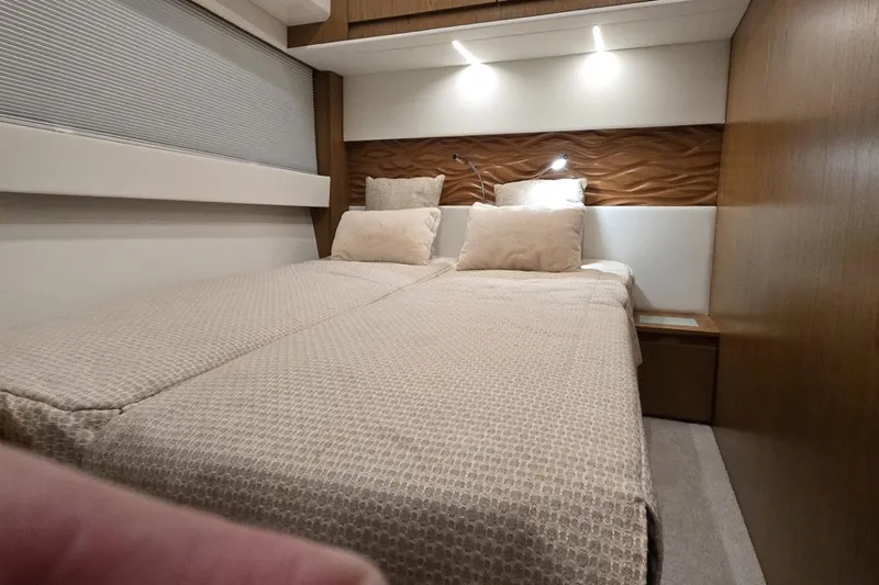 Jack's Boat Yacht Photos Pics Luxurious bedroom interior of 2024 Tiara Yachts EX 60 with modern lighting and elegant bedding.