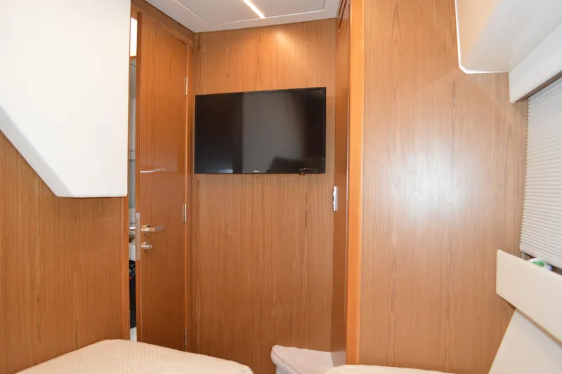 Jack's Boat Yacht Photos Pics 2024 Tiara Yachts EX 60 interior with wood paneling and wall-mounted TV.