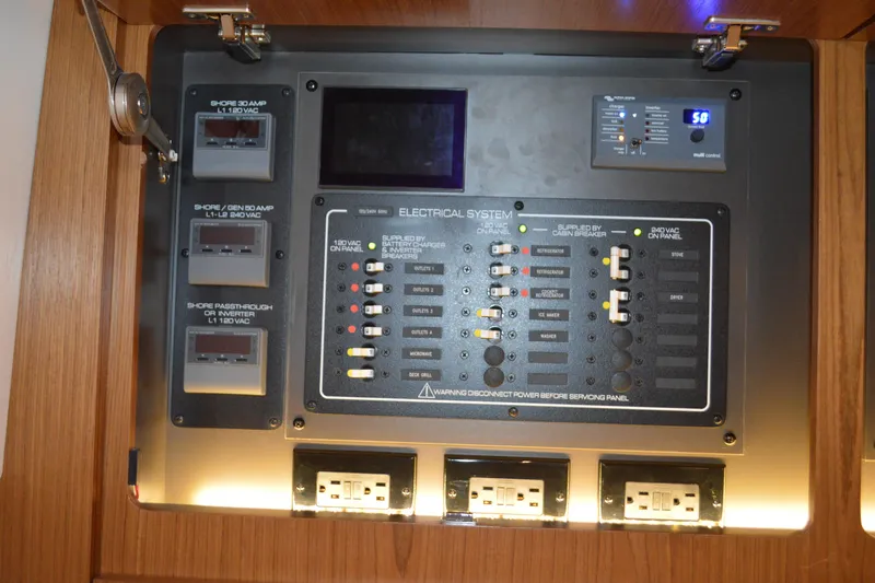 Jack's Boat Yacht Photos Pics Electrical control panel on 2024 Tiara Yachts EX 60, featuring various switches and outlets.