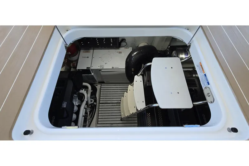 Jack's Boat Yacht Photos Pics Engine compartment of 2024 Tiara Yachts EX 60, showcasing mechanical components and access ladder.