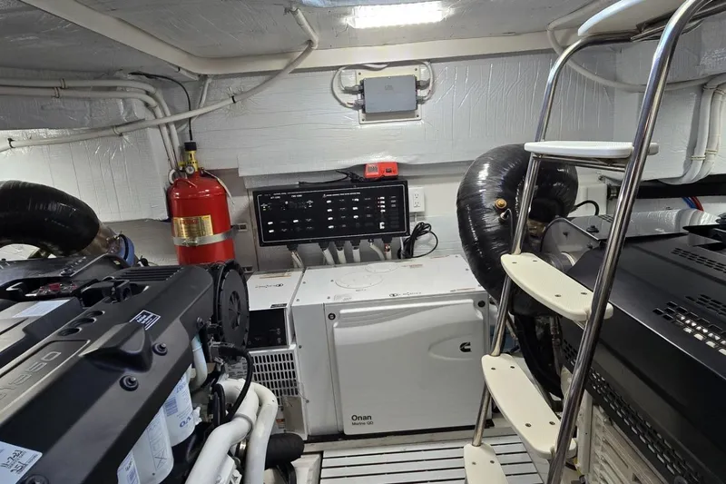 Jack's Boat Yacht Photos Pics Engine room of 2024 Tiara Yachts EX 60 with equipment and fire extinguisher.