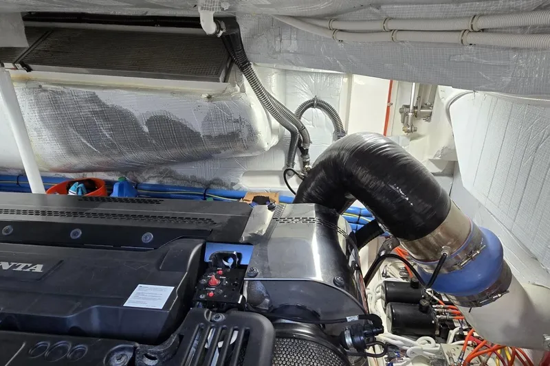 Jack's Boat Yacht Photos Pics Engine room of 2024 Tiara Yachts EX 60, showcasing mechanical components and piping.