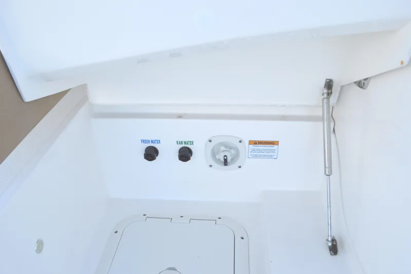 Jack's Boat Yacht Photos Pics 2024 Tiara Yachts EX 60 water access panel with fresh and raw water controls.