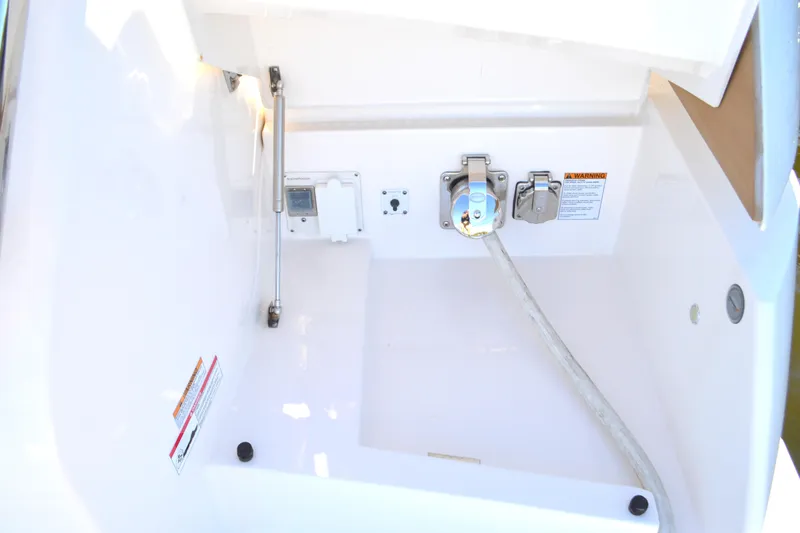 Jack's Boat Yacht Photos Pics 2024 Tiara Yachts EX 60 utility compartment with power connections and safety warnings.