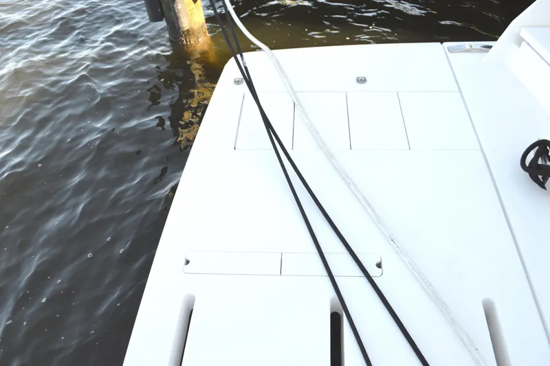 Jack's Boat Yacht Photos Pics 2024 Tiara Yachts EX 60 swim platform with ropes, docked by water.