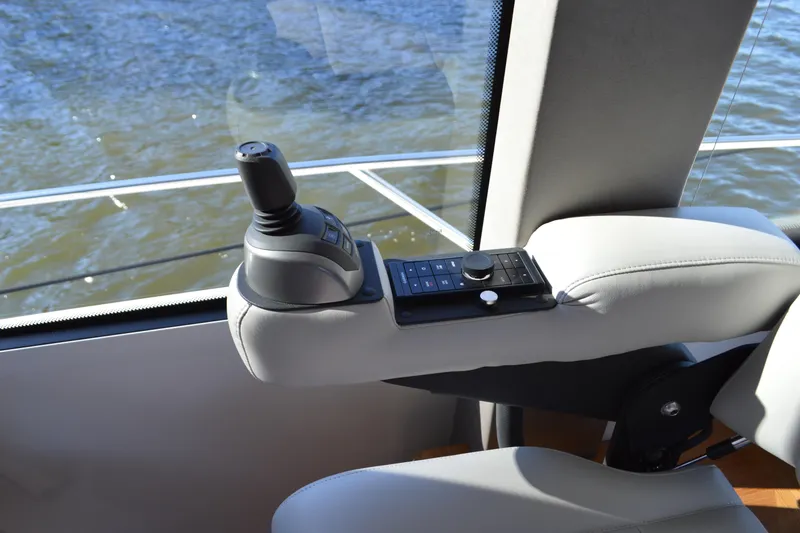 Jack's Boat Yacht Photos Pics 2024 Tiara Yachts EX 60 helm control, featuring joystick and control panel, overlooking water.