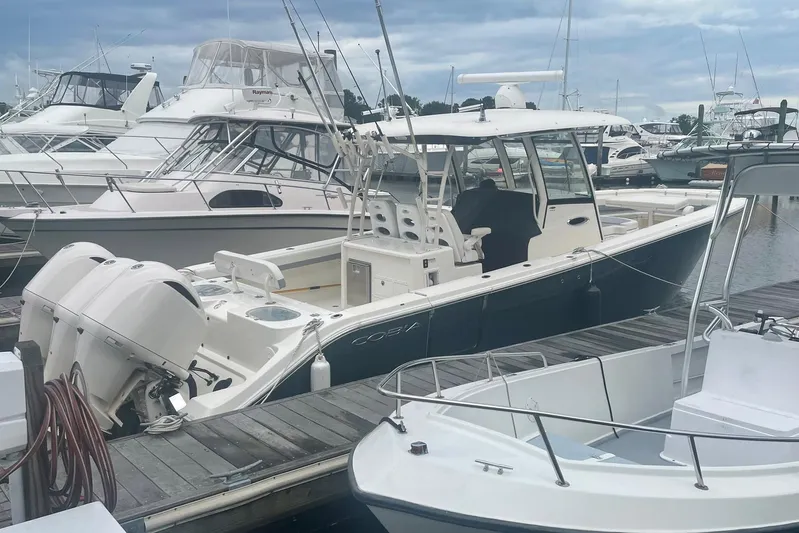 Pier Pressure Yacht Photos Pics 2018 Cobia 344 Center Console boat docked at marina with twin engines.