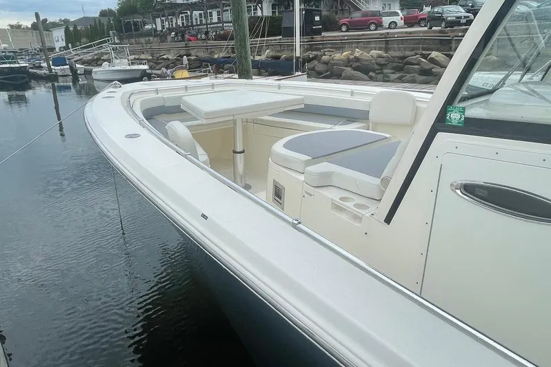 Pier Pressure Yacht Photos Pics 2018 Cobia 344 Center Console boat docked at marina, featuring spacious seating area.